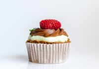 photograph of chocolate cupcake with red strawberry toppings