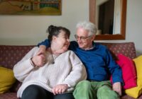 happy couple embracing on sofa