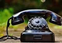 selective focus photography of black rotary phone