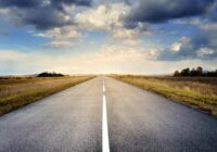 asphalt road under cloudy sky