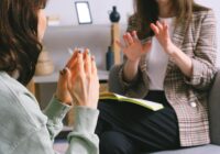 crop unrecognizable female psychologist and patient discussing mental problems during session